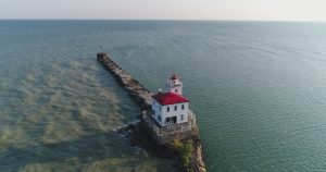Red and white lighthouse on the shore of lake erie
