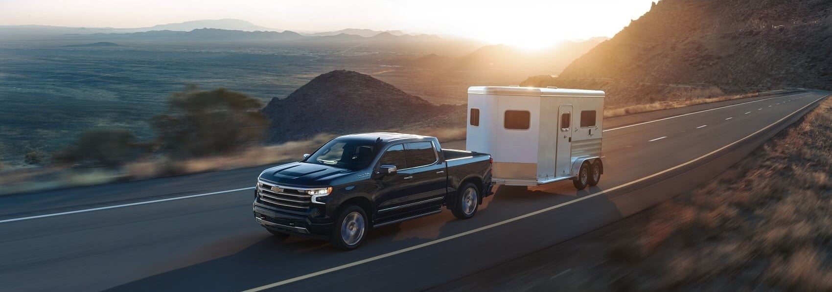 Black 2023 Chevy Silverado 1500 hauling trailer
